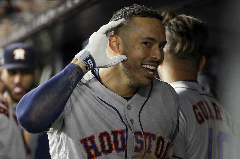Houston shortstop Carlos Correa reacts in the dugout Thursday after hitting a three-run home run in the sixth inning of the Astros’ 8-3 victory over the New York Yankees in Game 4 of the American League Championship Series at Yankee Stadium in New York.