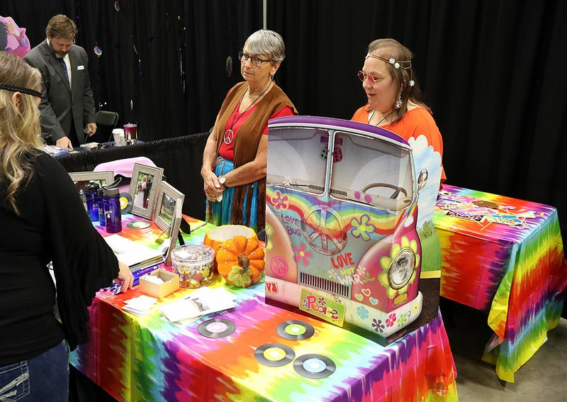 Janice Holder, left, and Patty Fulton work the Camp Couchdale booth at The Greater Hot Springs Chamber of Commerce's 2019 Business &amp; Career Expo on Thursday. - Photo by Richard Rasmussen of The Sentinel-Record