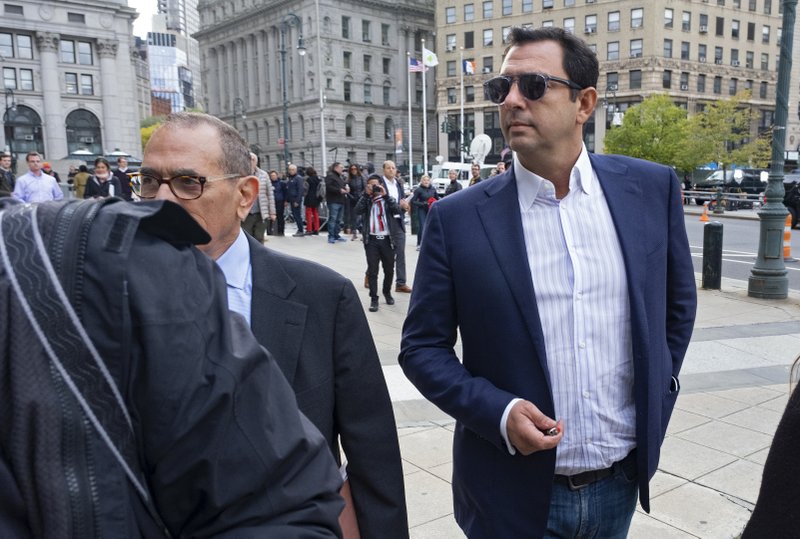 Andrey Kukushkin, right, leaves federal court, Thursday, Oct. 17, 2019, in New York. Kukushkin and David Correia pleaded not guilty Thursday to conspiring with associates of Rudy Giuliani to make illegal campaign contributions. They are among four men charged with using straw donors to make illegal contributions to politicians they thought could help their political and business interests.  (AP Photo/Craig Ruttle)