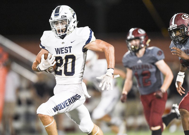 Bentonville West High School Nick Whitlatch (20) runs the ball for a score during a football game, Friday, October 4, 2019 at Springdale High School in Springdale.