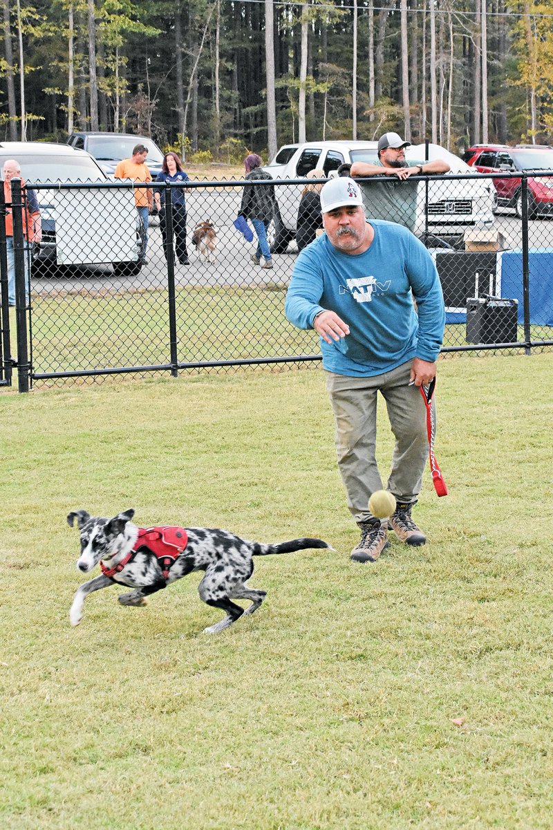 Charles Austin of Benton throws a ball for his dog, Casper, to fetch while attending the grand opening of the Bryant Bark Park on Oct. 14 at Alcoa 40 Park. The new dog park, at 1110 Shobe Road, has been open for a little more than a month, but thanks to the completion of the Bryant Parkway, the park is now more accessible to residents. 