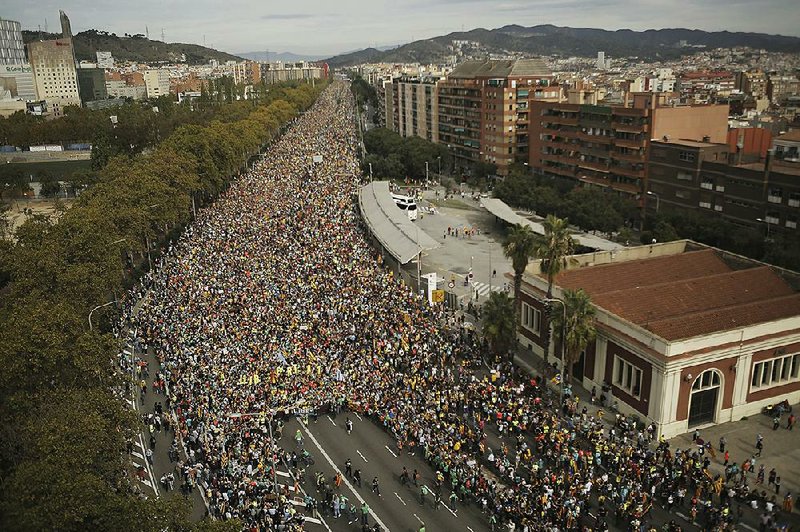 Demonstrators march into Barcelona, Spain, on Friday to protest the convictions of a dozen Catalan independence leaders. It was the fifth day of protests over the convictions, with flights into and out of the region canceled because of a strike called by pro-independence unions. More photos are available at arkansasonline.com/1019spain/. 