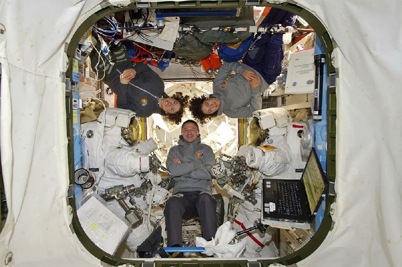 This photo provided by NASA shows astronauts Andrew Morgan, Christina Koch and Jessica Meir at the International Space Station on Friday. More photos are available at arkansasonline.com/1019nasa/ 