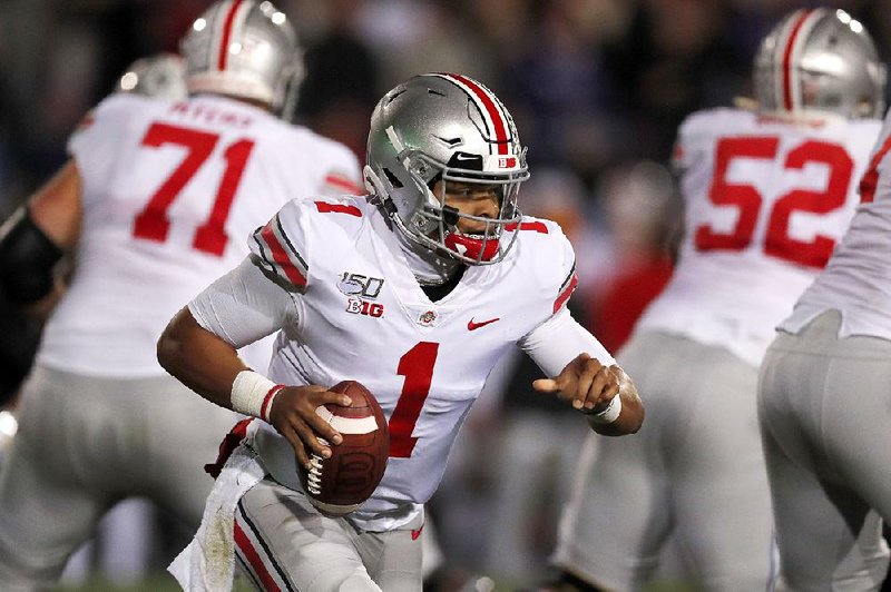 Quarterback Justin Fields threw for 194 yards and four touchdowns Friday to lead No. 4 Ohio State to a 52-3 victory over Northwestern in Evanston, Ill.