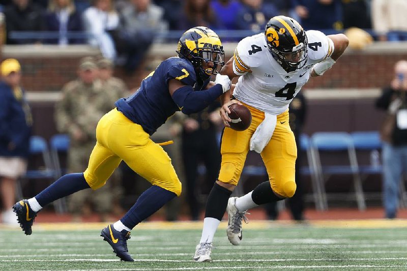 Michigan linebacker Khaleke Hudson (left), shown tackling Iowa quarterback Nate Stanley in a game earlier this month, knows the Wolverines will have their hands full today with Penn State quarterback Sean Clifford. “He’s got good accuracy. He’s got good scrambling ability. You can tell that he trusts the players around him,” Hudson said.