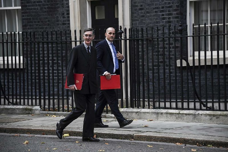 Britain’s Leader of the House of Commons Jacob Rees-Mogg (left) and lawmaker Jake Berry arrive at No. 10 Downing St. in London for a Cabinet meeting Friday. 