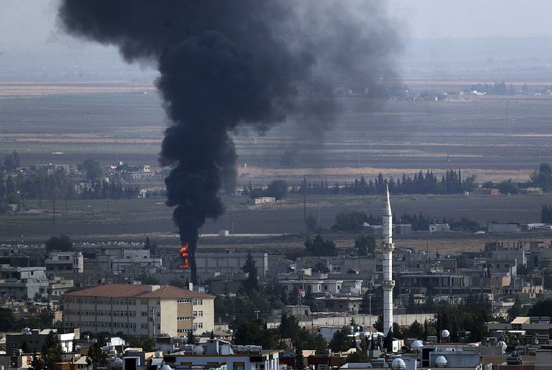 Smoke billows from a fire Friday in Ras al-Ayn, Syria, after fighting broke out that morning in the town on the border with Turkey, despite a cease-fire that went into effect the night before. 