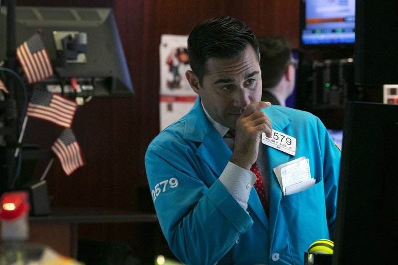 In this Oct. 2, 2019, file photo specialist William Geier works on the floor of the New York Stock Exchange.  (AP Photo/Richard Drew, File)