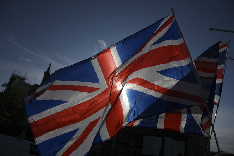 Union Jack flags fly outside the Houses of Parliament where pro and anti-Brexit supporters gathered in London, Saturday, Oct. 19, 2019. 