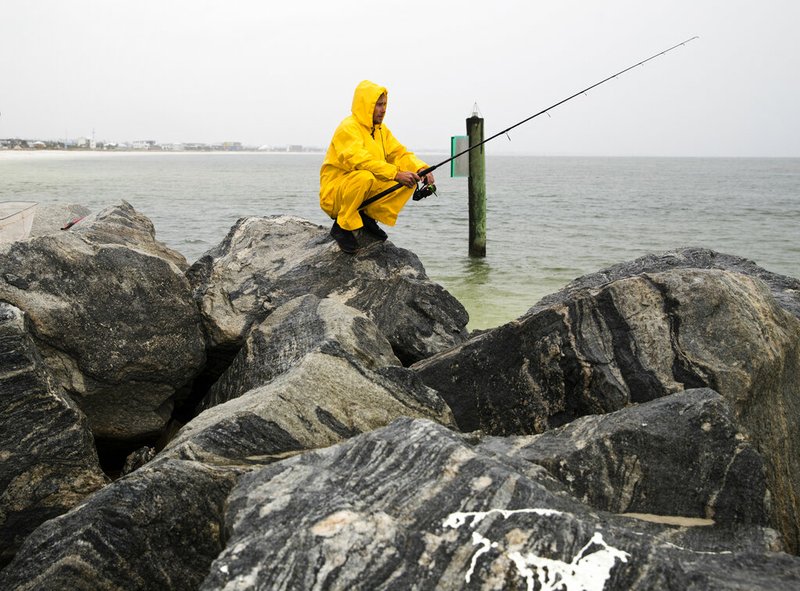 Michael Foster fishes as Tropical Storm Nestor approaches, Friday, Oct. 18, 2019 in Mexico Beach, Fla. Forecasters say a disturbance moving through the Gulf of Mexico has become Tropical Storm Nestor. 