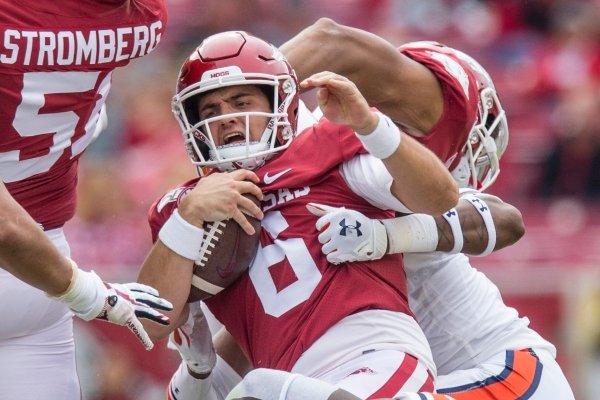 Derick Hall (29), Auburn buck, and Jamien Sherwood, Auburn defensive back, tackle Ben Hicks, Arkansas quarterback, for no gain in the second quarter Saturday, Oct. 19, 2019, at Reynolds Razorback Stadium in Fayetteville.