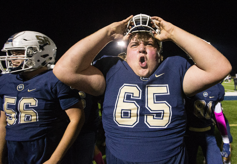 Ben Gann (left) and Coleton Smith, Bentonville West offensive linemen, celebrate after defeating Springdale Har-Ber Friday, Oct. 18, 2019, at Wolverine Stadium in Centerton.