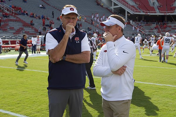 FILE — Auburn coach Gus Malzahn (left) and then-Arkansas coach Chad Morris speak prior to a game Saturday, Oct. 19, 2019, in Fayetteville.