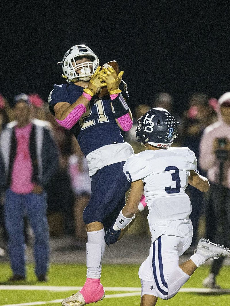 Bentonville West running back Jonas Higson makes a catch during  the Wolverines’ 24-20 victory over Springdale Har-Ber on Friday night in Centerton. Bentonville West moved to No. 4 in this week’s  rankings.  