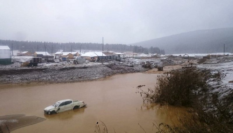 This image taken from video provided by the Russian Emergency Situations Ministry press service, shows the damage Saturday after a dam collapse near the village of Shchetinkino, Russia. 