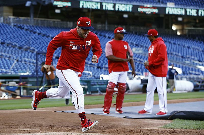 Washington Nationals second baseman Brian Dozier (left) participates in a workout Friday at Nationals Park in Washington, D.C. The Nationals open the World Series on Tuesday against the Houston Astros. 