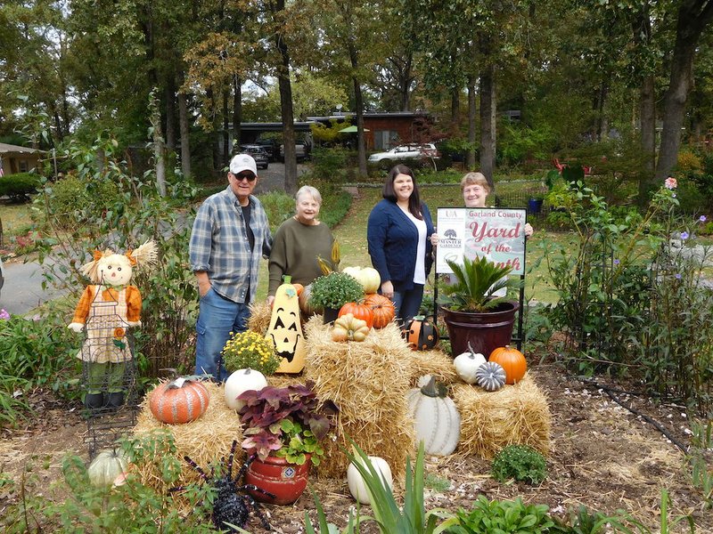 From left, homeowners Ron and Sharon Dent, Kristen Mangham, Special Events coordinator at Garvan Woodland Gardens, and Gaye Harper, Master Gardener, stand among the Dents' fall display of hay bales, pumpkins, scarecrows, ornamental cabbage and mums. Not pictured is Master Gardener Carolyn Davis. - Submitted photo