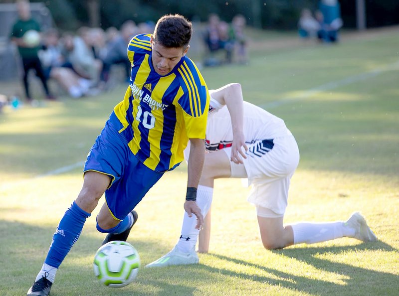 Photo courtesy of JBU Sports Information John Brown freshman Oscar Caraballo works his way around an Oklahoma Panhandle State defender during Thursday's match at Alumni Field.