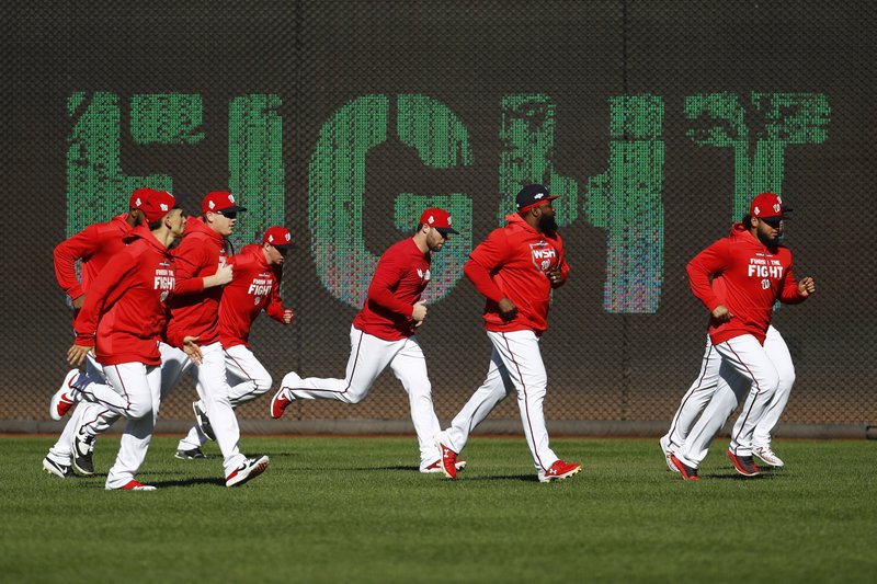 The Associated Press GAME PREP: Members of the Washington Nationals participate in a baseball workout Friday in Washington in advance of the team's appearance in the World Series.