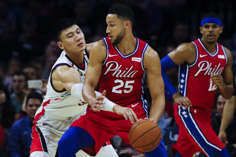 The Associated Press DRIVING THE LANE: Philadelphia 76ers' Ben Simmons (25) drives to the net Tuesday as Guangzhou Loong-Lions' Yongpeng Zhang defends and Philadelphia 76ers' Tobias Harris, right, watches during the first half of an NBA exhibition game in Philadelphia.