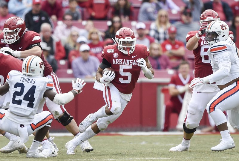 Arkansas running back Rakeem Boyd (5) carries the ball during the third quarter of Saturday's game at Donald W. Reynolds Razorback Stadium in Fayetteville. Photo by Charlie Kaijo of the NWA Democrat-Gazette