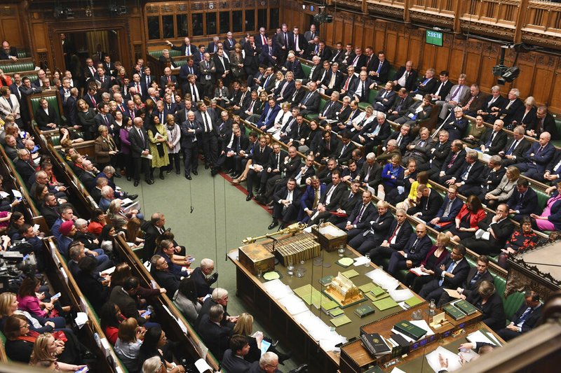 The House of Commons chamber is crowded by lawmakers during the Brexit debate inside parliament in London Saturday Oct. 19, 2019. At the rare weekend sitting of Parliament, Prime Minister Boris Johnson implored legislators to ratify the Brexit deal he struck this week with the other 27 EU leaders. Lawmakers voted Saturday in favour of the 'Letwin Amendment', which seeks to avoid a no-deal Brexit on October 31. (Jessica Taylor/House of Commons via AP)