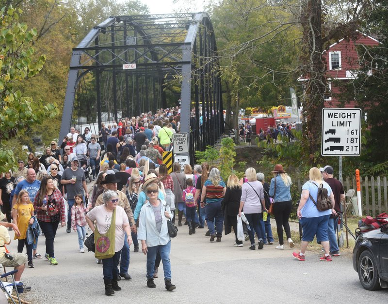 Fair-goers cross the historic War Eagle Bridge on Saturday Oct. 19 2019 en route to the annual War Eagle Fair. War Eagle is the area's original arts and crafts fair, founded in 1954 as a quilt show on the banks of the War Eagle River. Now thousands attend the four-day fair that continues today. Vendors report large crowds at this year's event. War Eagle Fair is on the west side of the river. Sharp Show crafts fair and the War Eagle Mill fair are on the east side of the river.