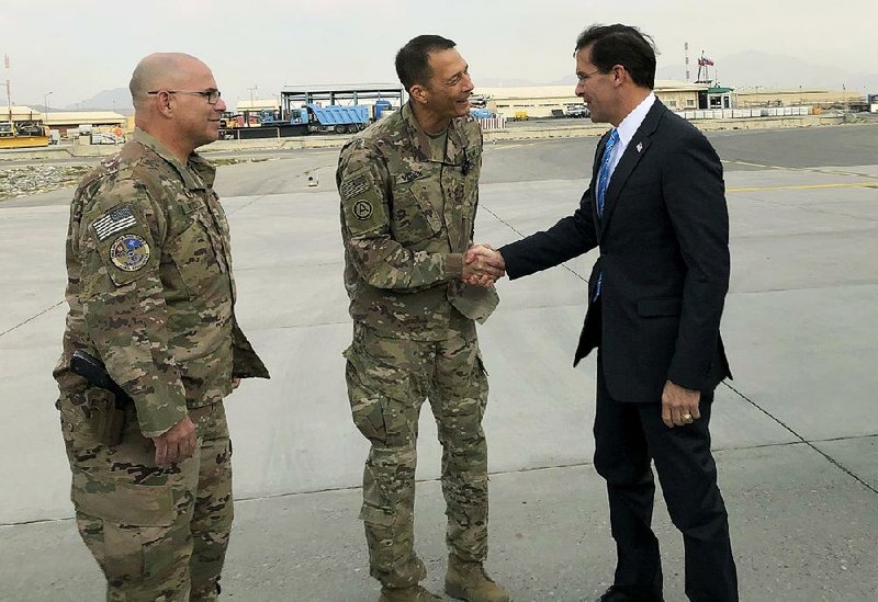 Defense Secretary Mark Esper is greeted by U.S. military personnel Sunday upon his arrival in Kabul, Afghanistan. Esper made his first visit to the country as Pentagon chief as peace talks with the Taliban remain stalled and renewed insurgent attacks complicate a planned withdrawal of American troops from the area. 