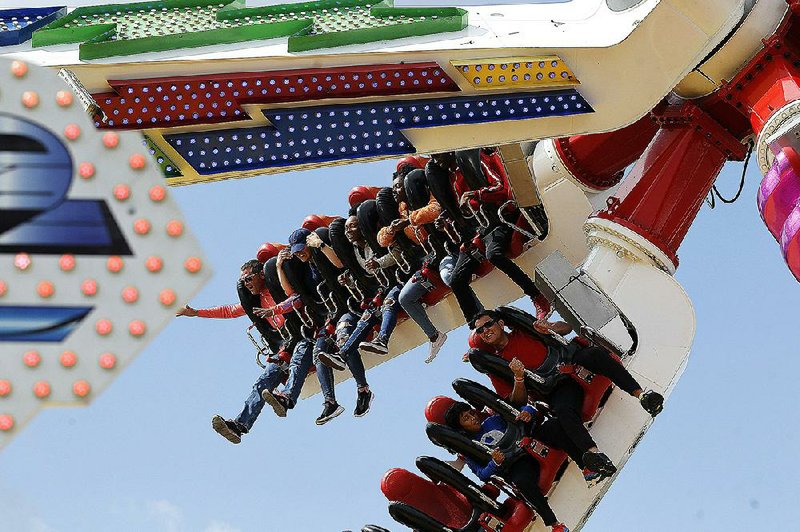 People take a spin on the Space Rider on Sunday, the final day of this year’s Arkansas State Fair in Little Rock. More photos are available atarkansasonline.com/1021fair/ 