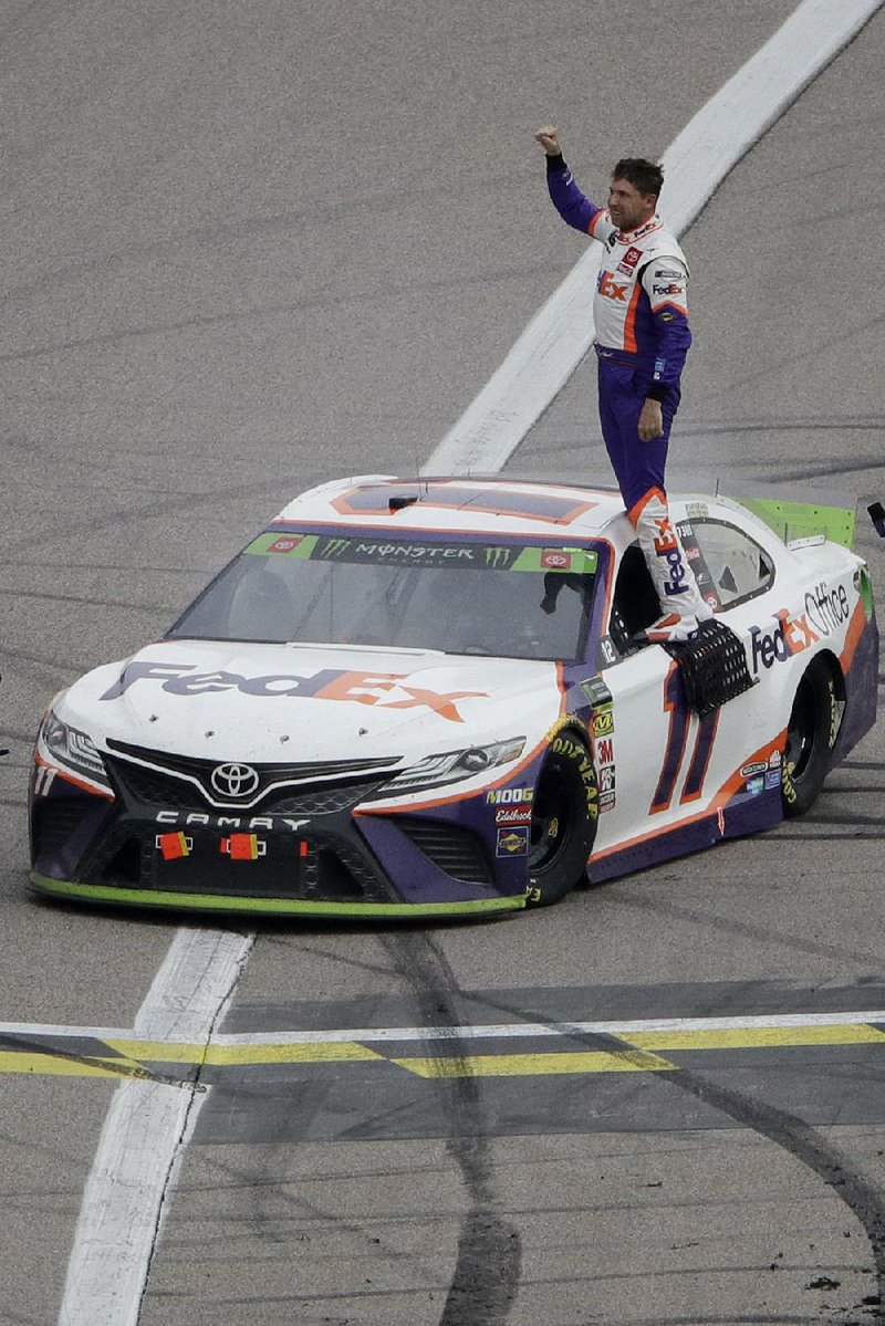 Denny Hamlin celebrates after winning the Hollywood Casino 400 at Kansas Speedway in Kansas City, Kan. The victory allowed Hamlin to advance to the next stage of the NASCAR Monster Energy Cup Series playoffs. 