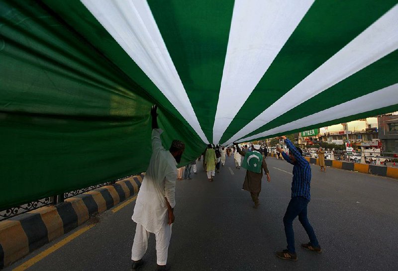 Ralliers in Islamabad, Pakistan, carry a 3-mile-long representation of a Kashmiri flag during a Sunday event to express solidarity with Indian Kashmiris. 