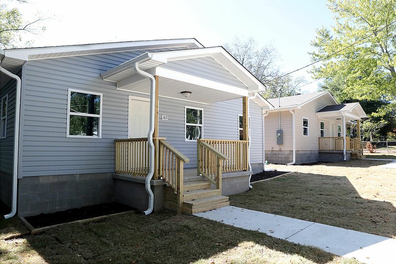 These two Habitat for Humanity homes in the 100 block of Watt Street were near completion on Friday. The Garland County Habitat for Humanity is now taking reservations for its annual application seminar for homes like these. - Photo by Richard Rasmussen of The Sentinel-Record