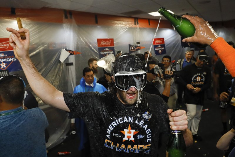 The Associated Press CAPITAL HILL: Houston Astros starting pitcher Gerrit Cole celebrates in the locker room Saturday after Game 6 of the American League Championship Series against the New York Yankees in Houston. The Astros won 6-4 to win the series 4-2.