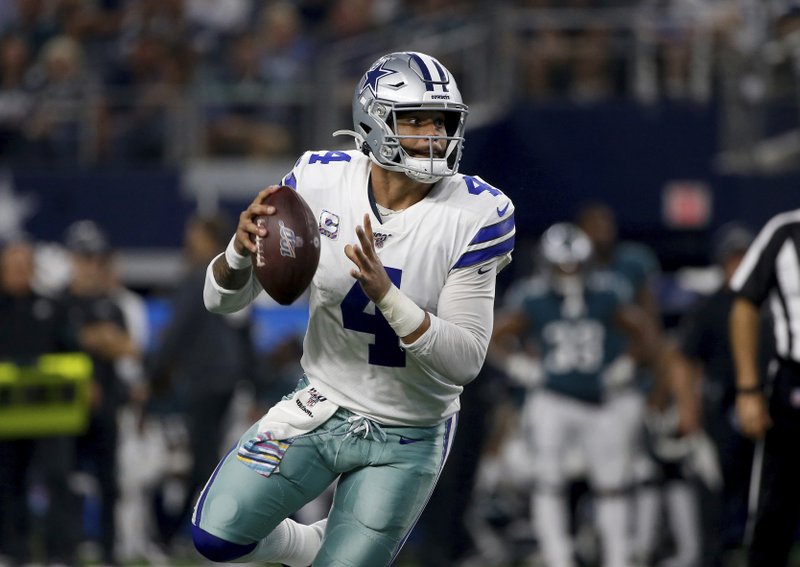 Dallas Cowboys quarterback Dak Prescott (4) runs the ball and reaches the end zone for a touchdown against the Philadelphia Eagles in the second half of Sunday's game in Arlington, Texas. Photo by Ron Jenkins of The Associated Press