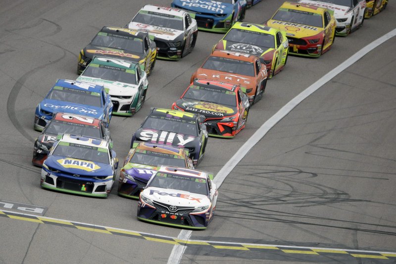 Denny Hamlin, front right, leads the pack out of the final caution before winning Sunday's NASCAR Cup Series race at Kansas Speedway in Kansas City, Kan. Photo by Charlie Riedel of The Associated Press