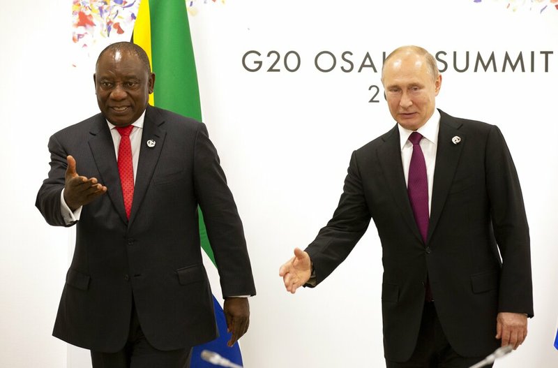 FILE- In this Friday, June 28, 2019 file photo, Russian President Vladimir Putin, right, and South African President Cyril Ramaphosa gesture prior to their talks on the sidelines of the G-20 summit in Osaka, western Japan. Putin is following China's lead and making a splashy bid for influence in Africa, hosting the majority of the continent's leaders this week in the first-ever Russia-Africa Summit. The Kremlin has said 47 of the continent's 54 heads of state or government are expected to attend.(AP Photo/Alexander Zemlianichenko, Pool)