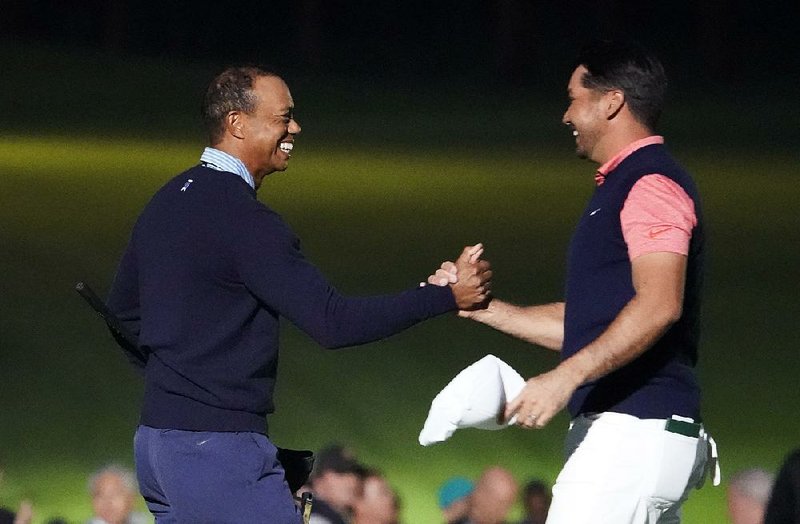 Tiger Woods and Jason Day (right) shake hands on the 18th hole after The Challenge: Japan Skins event Monday. Day won eight skins and $210,000 while Woods won five skins and $60,000. 