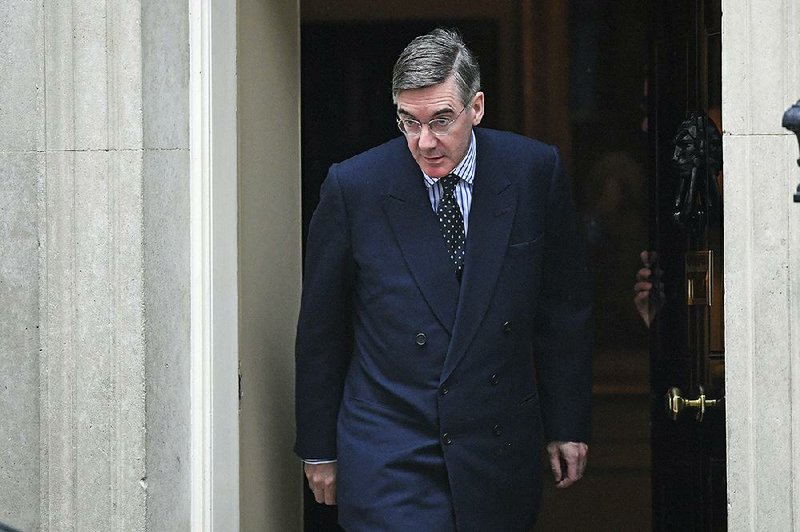 Jacob Rees-Mogg, leader of the House of Commons, leaves the prime minister’s office at No. 10 Downing St. in London on Monday. More photos are available at arkansasonline.com/1022brexit/. 