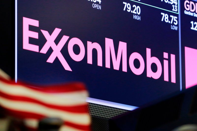 FILE - In this April 23, 2018, file photo, the logo for ExxonMobil appears above a trading post on the floor of the New York Stock Exchange. New York&#x2019;s attorney general is accusing Exxon Mobil of lying to investors about how profitable the company will remain as governments impose stricter regulations to combat global warming. The lawsuit is set to go to trial Tuesday, Oct. 22, 2019. (AP Photo/Richard Drew, File)
