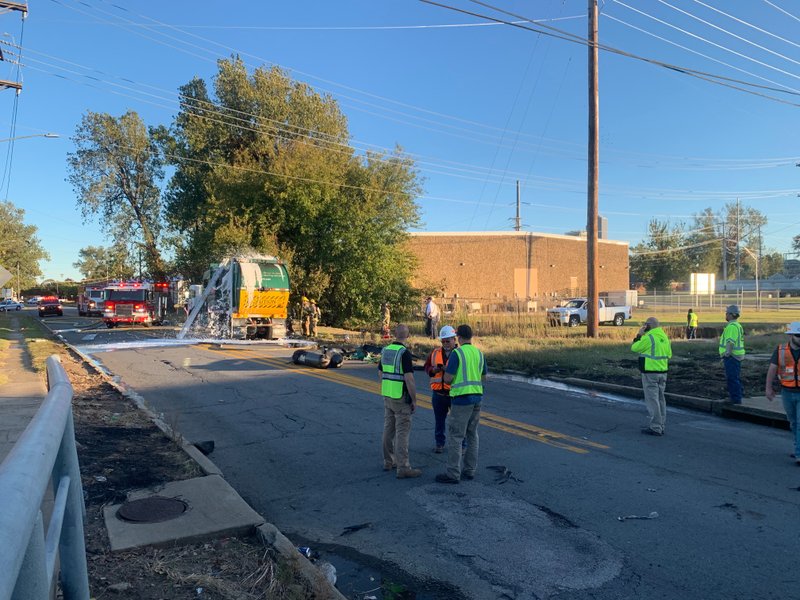 Workers respond to an explosion Tuesday in North Little Rock that injured a man and briefly shut down a railroad bridge.