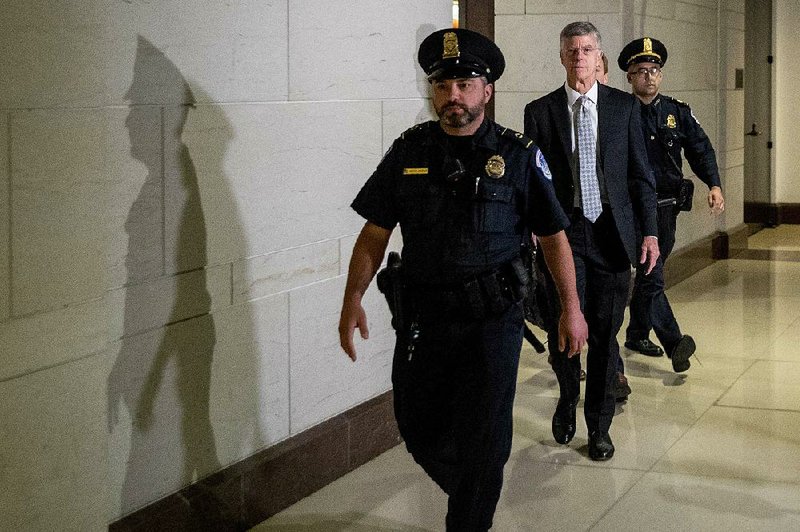 William Taylor (center), the acting U.S. ambassador to Ukraine, arrives Tuesday on Capitol Hill to testify in private about his concerns over President Donald Trump’s dealings with Ukraine and what he called “weird” secondary diplomatic channels. More photos at arkansasonline.com/1023taylor/ 