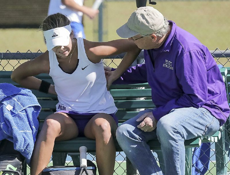 Presley Southerland (left) of Mount St. Mary talks to Coach Tim Glancy on Tuesday after withdrawing from the girls singles final at the Overall state tennis tournament because of back issues. 