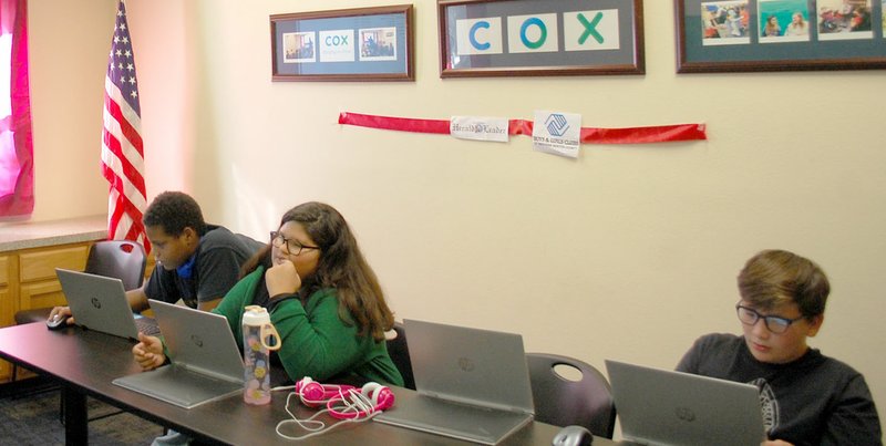 Marc Hayot/Herald-Leader Today's youth spend more time online than previous generations. Trendon Lovell (left), Ella Mitleff and Christian Mitchell are busy working on their projects at the Boys &amp; Girls Club.