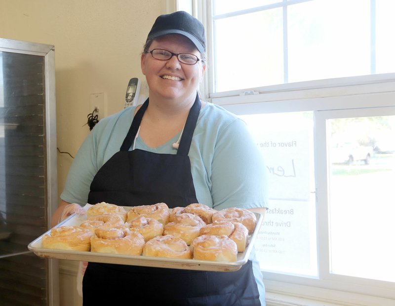 LYNN KUTTER ENTERPRISE-LEADER Breanna Center takes care of the drive-through window at the new Fat Rolls bakery in Lincoln. The bakery, based in Prairie Grove, expanded to the building at 810 E. Pridemore about a month ago.