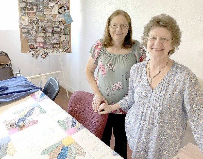 DENISE NEMEC SPECIAL TO ENTERPRISE-LEADER Central members Judy Cohea (left) and Marty Lunsford stand by the quilt the Quilter's Group is making for the church's 2020 Thanksgiving Feast.