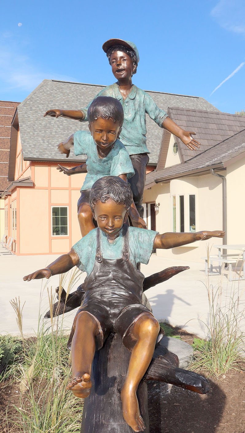LYNN KUTTER ENTERPRISE-LEADER The faces of the children of a new sculpture in Farmington show the joy of playing outside and playing with friends. The sculpture can be seen in front of Farmington Village on Main Street.