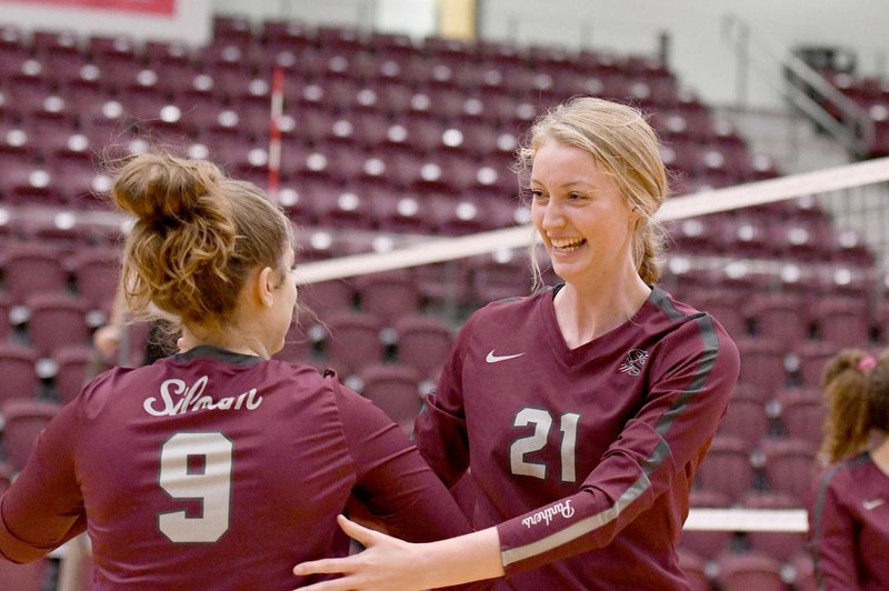 Bud Sullins/Special to the Herald-Leader Siloam Springs senior Abby Hornbuckle (left) is greeted by senior teammate Abby Herring during a substitution in a home match against Vilonia on Oct. 15.