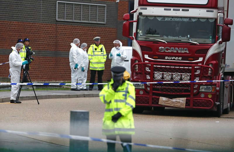 Police forensic officers attend the scene after a truck was found to contain a large number of dead bodies, in Thurrock, South England, Wednesday Oct. 23, 2019. Police in southeastern England said that 39 people were found dead Wednesday inside a truck container believed to have come from Bulgaria. (AP Photo/Alastair Grant)