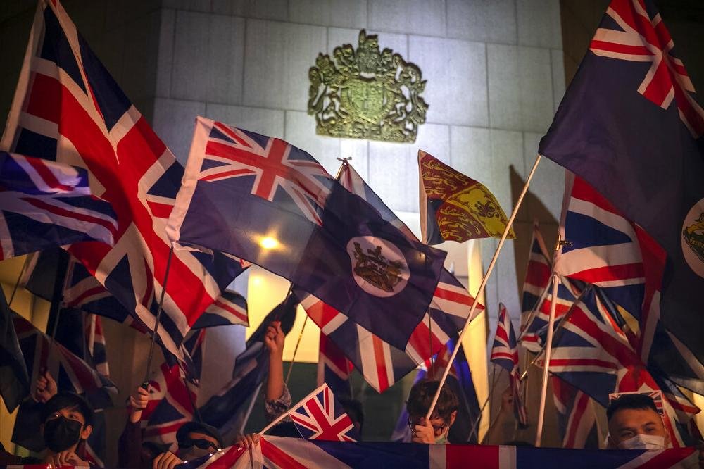 Demonstrators Wave British Flags During A Rally Outside Of The British 