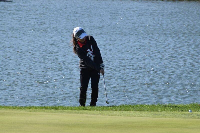 RICK PECK/SPECIAL TO MCDONALD COUNTY PRESS Lily Allman chips from the water's edge during her second round on Oct. 22 during the Missouri Class 2 Girls Golf Championships at Silo Ridge Golf and Country Club in Bolivar.